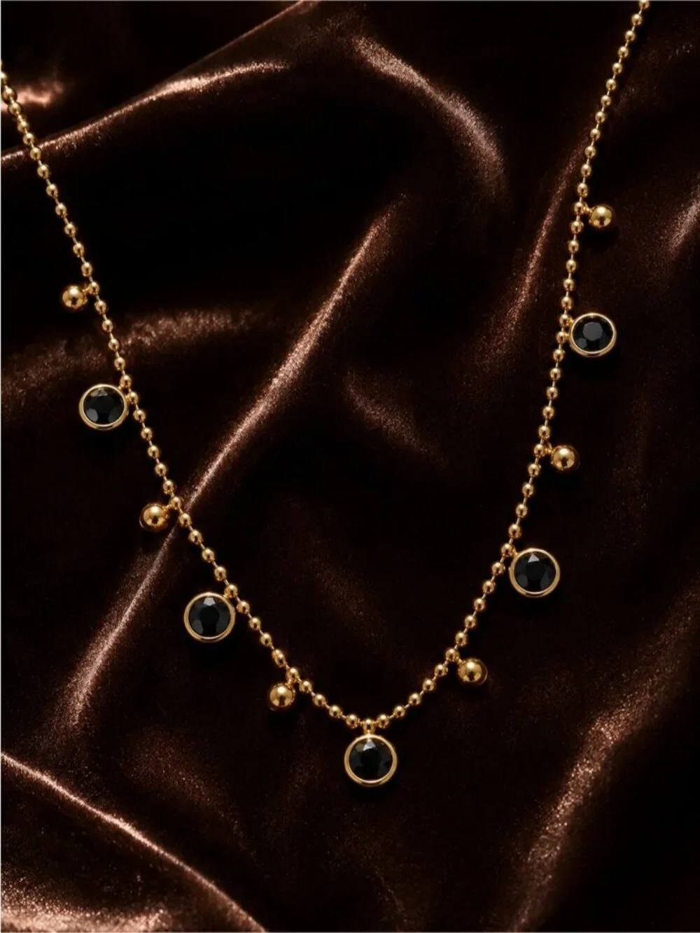 Gold olated Bead Necklace with Black Cabochons